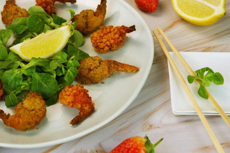 a white plate topped with shrimp and greens